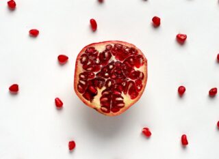 red sliced fruit on white surface